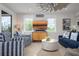 Bright living room with stylish furniture and a coastal-themed ceiling fan at 915 N Shore Dr, Anna Maria, FL 34216