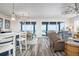 Bright living room with ocean views, and an open concept layout to kitchen and dining areas at 915 N Shore Dr, Anna Maria, FL 34216