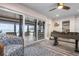 Relaxing living room featuring an ocean view through large sliding doors and a foosball table for entertainment at 915 N Shore Dr, Anna Maria, FL 34216