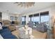 Stylish living room with ocean views, sliding glass doors, and comfortable seating at 915 N Shore Dr, Anna Maria, FL 34216