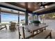 Charming covered patio with dining furniture offering tranquil ocean views at 915 N Shore Dr, Anna Maria, FL 34216