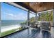 Serene covered patio with comfortable seating and picturesque ocean views at 915 N Shore Dr, Anna Maria, FL 34216
