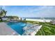 Beautiful pool and lounging area with ocean views and manicured green lawn at 915 N Shore Dr, Anna Maria, FL 34216