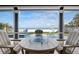 Outdoor seating near a pool and a fire pit with a beautiful ocean view at 915 N Shore Dr, Anna Maria, FL 34216