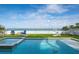 Inviting pool with ocean views and lush artificial turf, perfect for relaxation at 915 N Shore Dr, Anna Maria, FL 34216