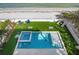 Birds eye view of backyard pool and spa featuring a spacious yard with beach views at 915 N Shore Dr, Anna Maria, FL 34216