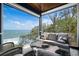 Relaxing porch with comfortable seating and ocean views provides a serene spot to unwind and enjoy the outdoors at 915 N Shore Dr, Anna Maria, FL 34216