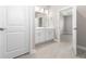 Bathroom with tile floors, white vanity, and an open doorway leading to a bedroom at 1342 Shaker Ln, North Port, FL 34286