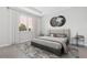 Inviting bedroom with a large window, neutral color scheme, and stylish decor at 1342 Shaker Ln, North Port, FL 34286