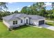 Modern single-story home featuring a lush green lawn, new roof, neutral color palette, and an attached two-car garage at 1342 Shaker Ln, North Port, FL 34286