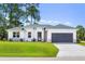 Charming single-story home featuring a well-manicured lawn and an attached two-car garage at 1342 Shaker Ln, North Port, FL 34286