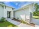 Stylish home with modern architecture, a welcoming walkway, and decorative stone accents enhancing the facade at 1342 Shaker Ln, North Port, FL 34286