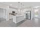 Bright kitchen featuring stainless steel appliances, white cabinets, and a functional island at 1342 Shaker Ln, North Port, FL 34286