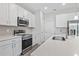 Updated kitchen features stainless appliances, a modern sink, and pristine white countertops at 1342 Shaker Ln, North Port, FL 34286