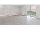 Spacious living room with sliding glass doors leading to a fenced yard at 1342 Shaker Ln, North Port, FL 34286