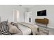 Comfortable bedroom with modern decor, TV, and easy access to en-suite bathroom at 1342 Shaker Ln, North Port, FL 34286