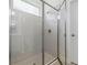 Modern bathroom shower with glass enclosure, neutral tile, and updated fixtures at 1342 Shaker Ln, North Port, FL 34286