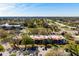 Aerial view of condos with red tile roofs in a well-maintained community with mature trees at 3201 Beneva Rd # 204, Sarasota, FL 34232