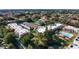 Aerial view of community boasts condos, tennis court, pool, landscaping and a small lake with fountain at 3201 Beneva Rd # 204, Sarasota, FL 34232