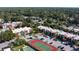 Aerial view showcasing community condos, tennis courts, and lush trees at 3201 Beneva Rd # 204, Sarasota, FL 34232