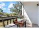Balcony featuring a table and seating overlooking a lush green landscape under a blue sky at 3201 Beneva Rd # 204, Sarasota, FL 34232