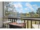 Balcony featuring a table and seating overlooking a lush green landscape under a blue sky at 3201 Beneva Rd # 204, Sarasota, FL 34232