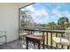 Balcony featuring a table and seating overlooking a lush green landscape under a blue sky at 3201 Beneva Rd # 204, Sarasota, FL 34232