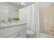 Bright bathroom features a white vanity, decorative countertop, and shower with white curtain at 3201 Beneva Rd # 204, Sarasota, FL 34232