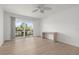 Bright bedroom with sliding glass doors to balcony and light wood flooring at 3201 Beneva Rd # 204, Sarasota, FL 34232