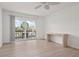 Bright bedroom with sliding glass doors to balcony and light wood flooring at 3201 Beneva Rd # 204, Sarasota, FL 34232