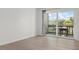 Bright bedroom features wood floors, and sliding glass doors to outdoor balcony with seating at 3201 Beneva Rd # 204, Sarasota, FL 34232