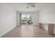 Bright bedroom with sliding glass doors to balcony and light wood flooring at 3201 Beneva Rd # 204, Sarasota, FL 34232