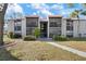 Inviting condo exterior featuring a red tile roof, balconies, and landscaped grounds at 3201 Beneva Rd # 204, Sarasota, FL 34232