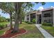 Charming condo exterior featuring a red tile roof, balconies, and mature trees at 3201 Beneva Rd # 204, Sarasota, FL 34232