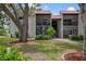 Attractive condo exterior with a red tile roof, balconies, and well-manicured lawn at 3201 Beneva Rd # 204, Sarasota, FL 34232