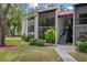 Welcoming condo exterior with a red tile roof, balconies, and lush landscaping at 3201 Beneva Rd # 204, Sarasota, FL 34232