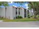 Exterior of condo building features a red tile roof and green landscaping at 3201 Beneva Rd # 204, Sarasota, FL 34232