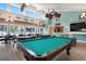 Spacious game room with pool table, high ceilings, ceiling fans, and an open kitchen bar at 3201 Beneva Rd # 204, Sarasota, FL 34232