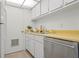 Kitchen with stainless steel appliances, white cabinets, and light counter tops at 3201 Beneva Rd # 204, Sarasota, FL 34232