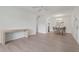 Open concept living area with light wood flooring, ceiling fan, and dining area with table and chairs at 3201 Beneva Rd # 204, Sarasota, FL 34232