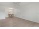 Bright living area featuring wood floors, a ceiling fan, and a dining area set for four at 3201 Beneva Rd # 204, Sarasota, FL 34232