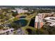Scenic aerial view of a building nestled in a community with a golf course and lush landscaping with ponds at 4570 Pinebrook Cir # 303, Bradenton, FL 34209