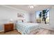 Bright bedroom with a large window overlooking palm trees at 4570 Pinebrook Cir # 303, Bradenton, FL 34209