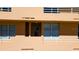 A condo building's exterior showing balconies with white railings and windows for each unit at 4570 Pinebrook Cir # 303, Bradenton, FL 34209