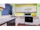 Efficient kitchen with white cabinets, modern appliances, and a convenient pass-through to the dining area at 4570 Pinebrook Cir # 303, Bradenton, FL 34209