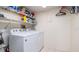 Functional laundry room equipped with a washer, dryer, and ample shelving for storage, providing convenience at 4570 Pinebrook Cir # 303, Bradenton, FL 34209