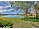 Spacious backyard showcasing well-maintained lawn and serene lake view at 4914 Lakescene Pl, Sarasota, FL 34243