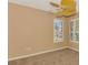 Bedroom with a ceiling fan and carpeted floors with two large windows at 4914 Lakescene Pl, Sarasota, FL 34243