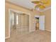 Bedroom featuring mirrored closet doors and a view to the kitchen at 4914 Lakescene Pl, Sarasota, FL 34243