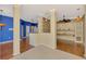 Stylish dining area showcases hardwood floors, built-in shelving, and a colorful accent wall at 4914 Lakescene Pl, Sarasota, FL 34243